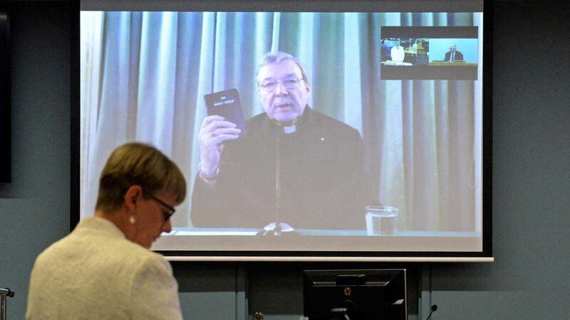 Cardinal George Pell appears from Rome, Italy, on a screen as he testifies at an extraordinary public hearing of an Australian investigative commission just a few blocks from the Vatican 