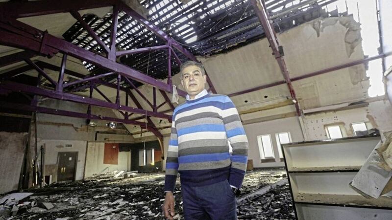 Muhammad Atif, a trustee of the Belfast Multi-Cultural Association, at its building destroyed in a a racist arson attack in January last year. Picture by Hugh Russell 
