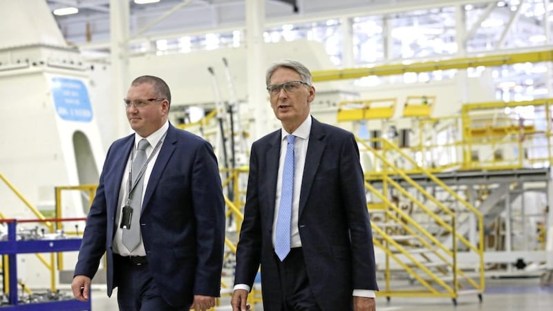 Chancellor of the Exchequer Phillip Hammond (right) with Jonathan Connell, vice president of operations, during his visit to the Bombardier factory in Belfast 