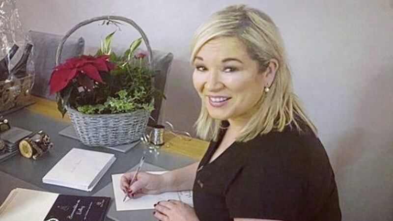 Deputy First Minister Michelle O&#39;Neill writing her specially designed Christmas card 