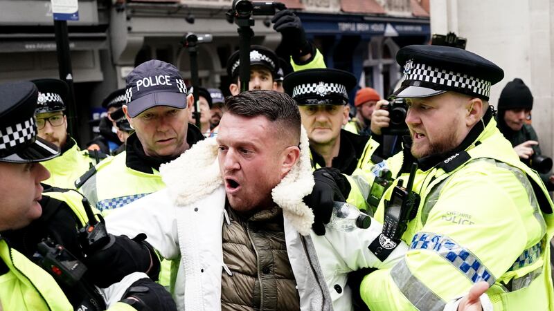 Tommy Robinson is led away by police officers as people take part in a march against antisemitism organised by the volunteer-led charity Campaign Against Antisemitism at the Royal Courts of Justice in London (Jordan Pettitt/PA)