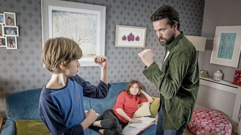 Max (Callum Booth-Ford) is encouraged by his father Stephen (Emmett J Scanlan) to engage in manly pursuits in new ITV drama Butterfly. Picture (C) iTV  