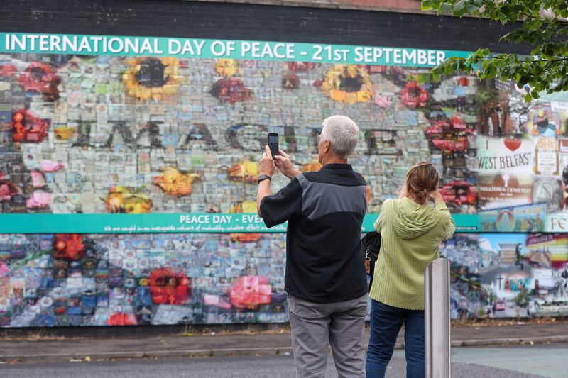 Tourists visit the international mural wall on the Falls Road, west Belfast. Picture by Mal McCann