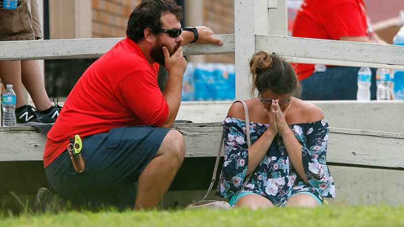 &nbsp;A woman prays in the grass outside the Alamo Gym where parents wait to reunite with their kids following a shooting at Santa Fe High School today in Santa Fe, Texas. Picture by&nbsp;Michael Ciaglo/Houston Chronicle via AP