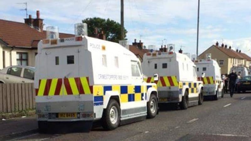 Police Land Rovers lined up outside the home of independent councillor, Gary Donnelly. 