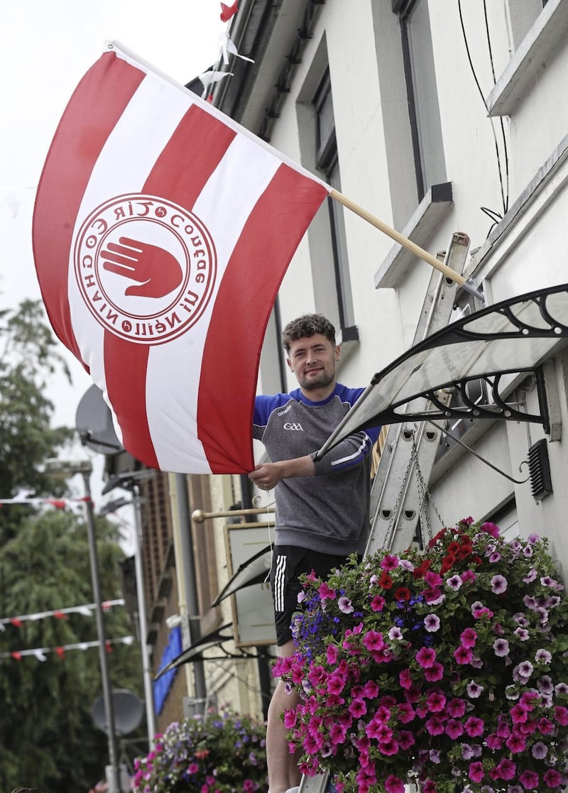 Ronan Christie erecting Tyrone flags in Donaghmore ahead of Saturday&#39;s big game. Picture by Hugh Russell 