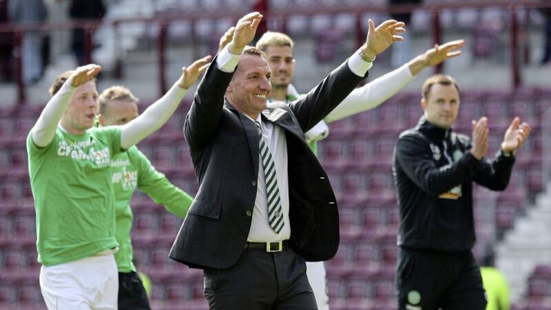 Celtic manager Brendan Rodgers and his players celebrate with the fans after winning the Scottish Premiership league title with a 5-0 thrashing of Hearts at Tynecastle Stadium, Edinburgh on Sunday April 2 2017. 