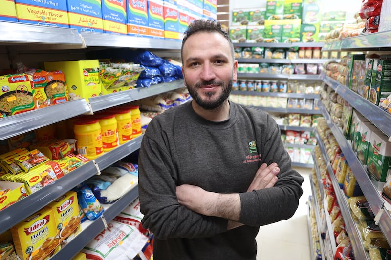 Ahmad Alkhamran from Syria at his newly opened Al Rayan Supermarket on the Falls Road in west Belfast, pictured with SDLP councilor Paul Doherty. Ahmad's former premises on the Donegall Road in south Belfast was attacked and set on fire. PICTURE: MAL MCCANN