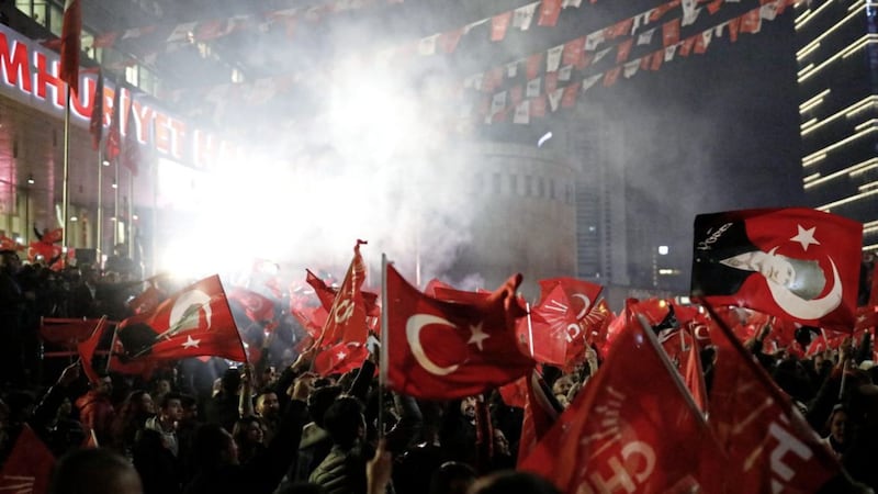 Supporters of the Republican People&#39;s Party, CHP, wave Turkish flags, and one with a portrait of Kemal Ataturk, right, as they celebrate after preliminary results of the local elections were announced in Ankara, Turkey, on Monday, April 1, 2019. Picture by Burhan Ozbilici, Associated Press 