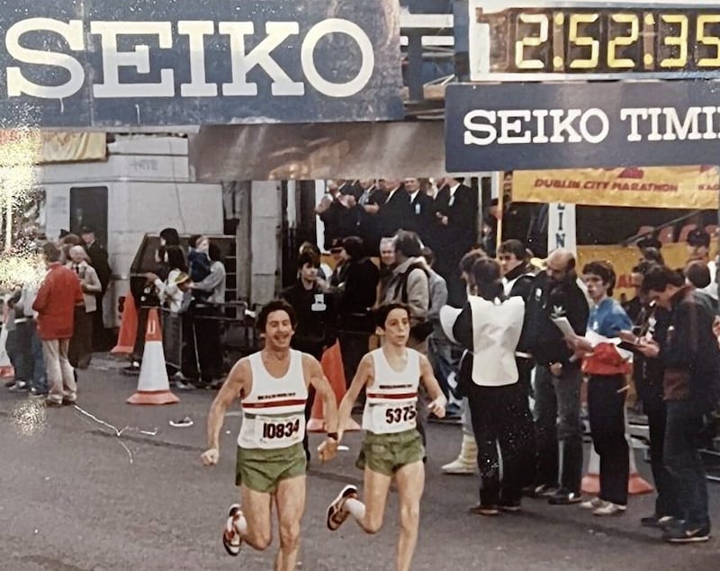 Jim Kennedy (left) crosses the finish line at the Dublin City Marathon in 1983 with his son, Stuart 