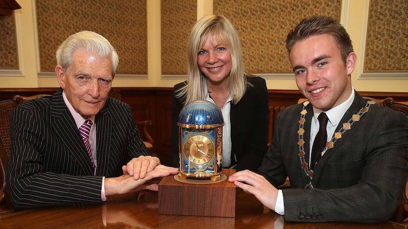 The Titanic clock is handed over to deputy lord mayor Guy Spence and Belfast City Council chief executive Suzanne Wylie by Irish News chairman Jim Fitzpatrick. Picture by Mal McCann 