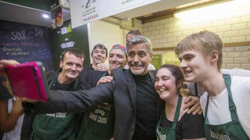 George Clooney taking a selfie with staff as he visits Social Bite cafe in Edinburgh. Picture by Jeff Holmes/PA