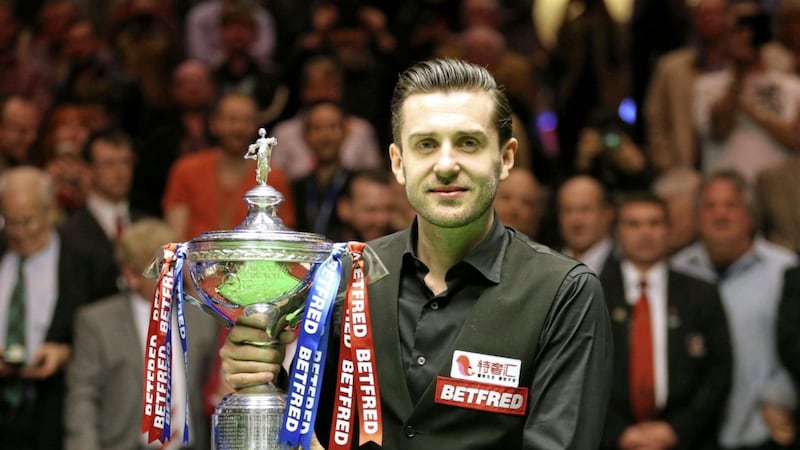 Mark Selby celebrates winning the Betfred Snooker World Championship last night Picture by PA 