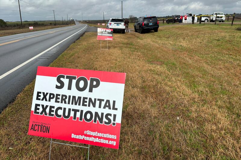 Anti-death penalty signs placed by activists stand along the road heading to Holman Correctional Facility in Atmore, Alabama (AP Photo/Kim Chandler, File)