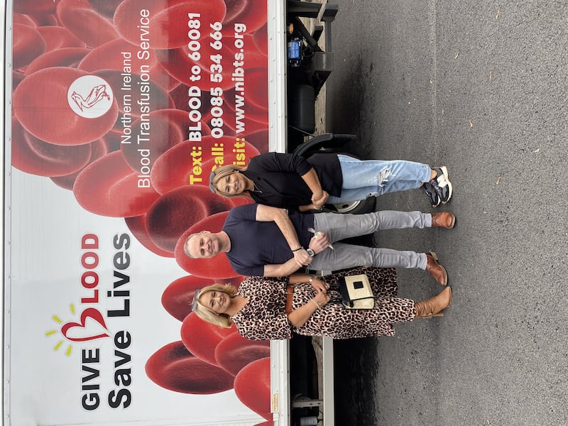 Holly's mum Claire, uncle Mark Kelly and auntie Geraldine Robinson outside the Northern Ireland Blood Transfusion Service's 'Blood Mobile'.
